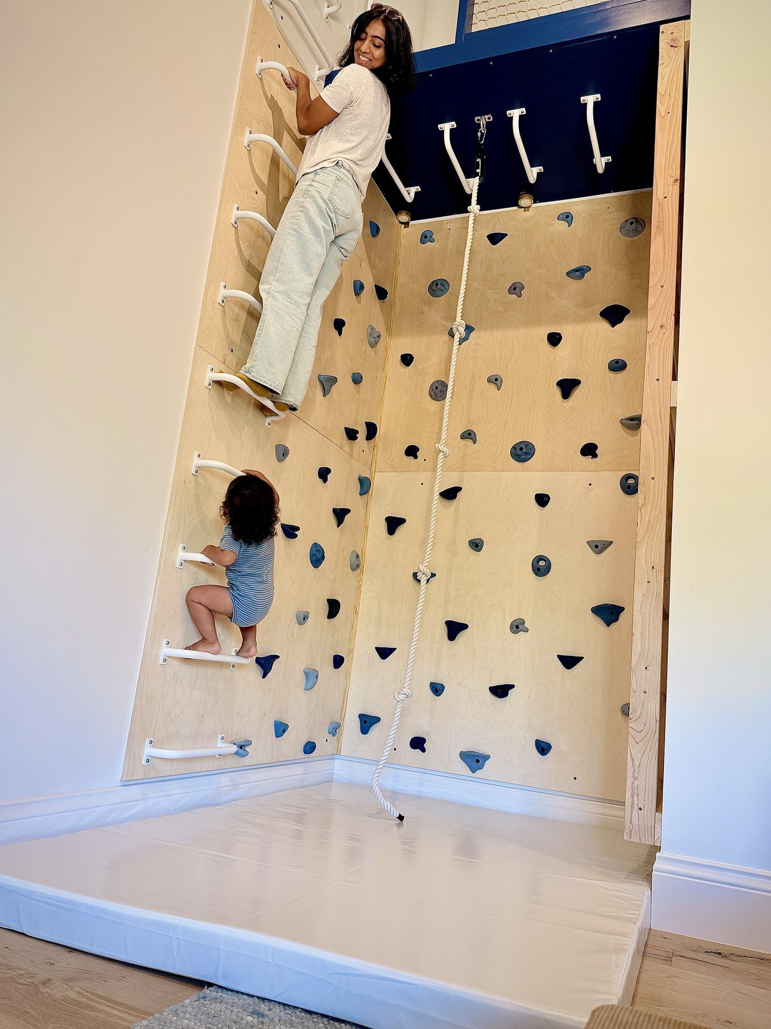 A grown-up and a child climbing together