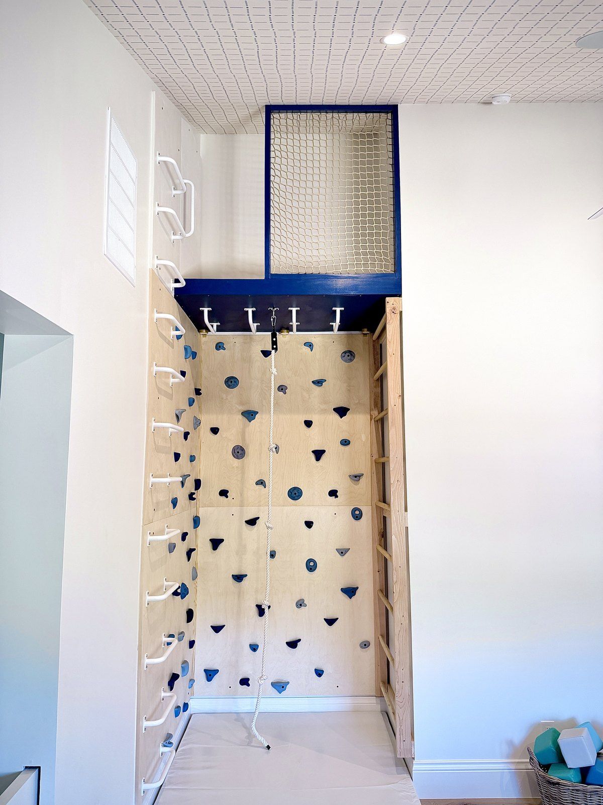 After: the climbing wall, rungs, overhead bars and blue loft