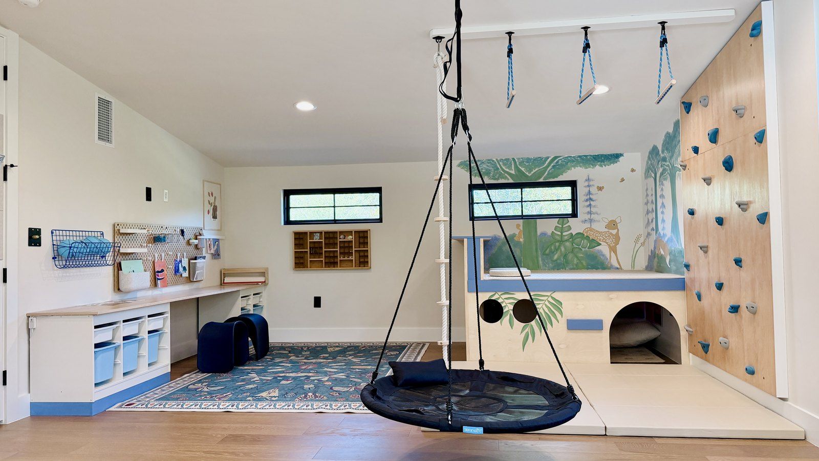 After: the platform, climbing wall, trapeze and nest swing under the sloped ceiling