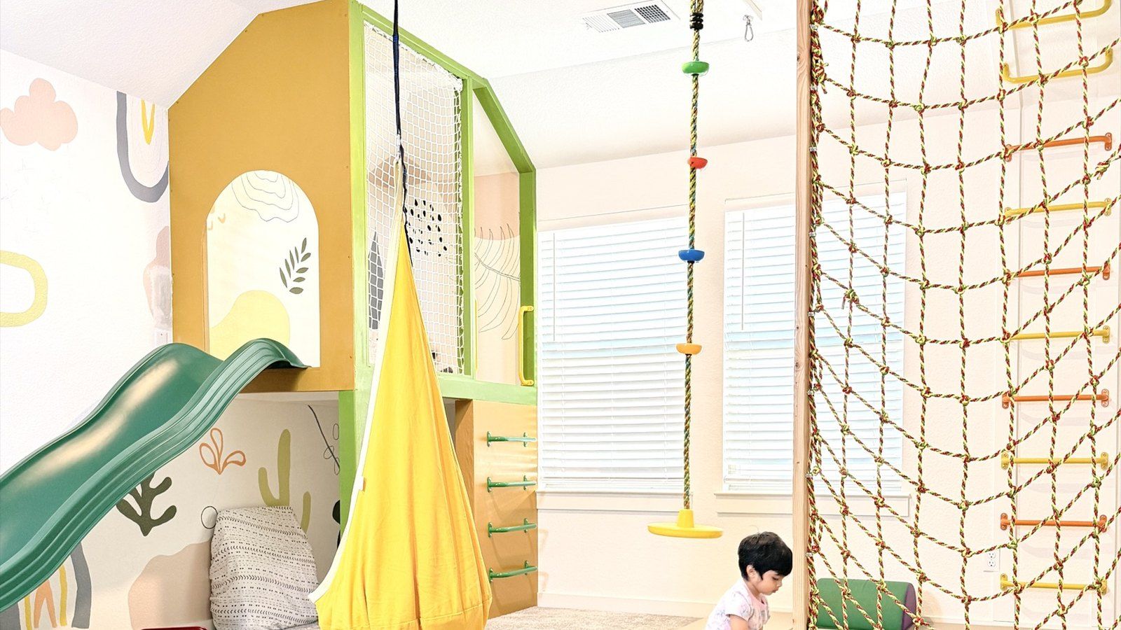 After: the Sunshine House playhouse, slide, pod swing and rope net