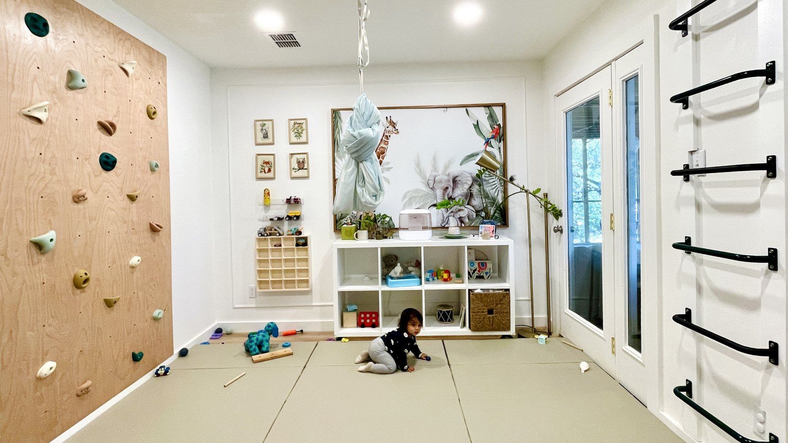 After: the climbing wall, black wall bars, overhead rings and padded floor