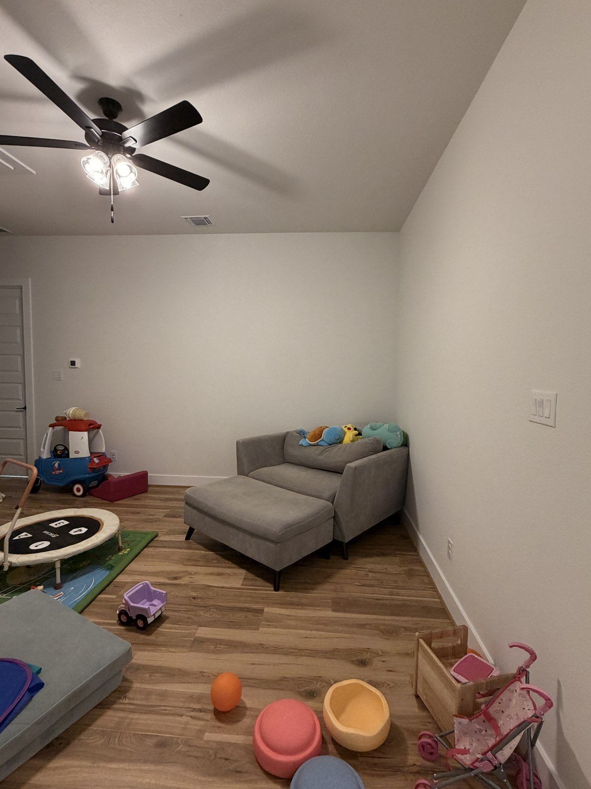Before: the same room with a sofa and toys