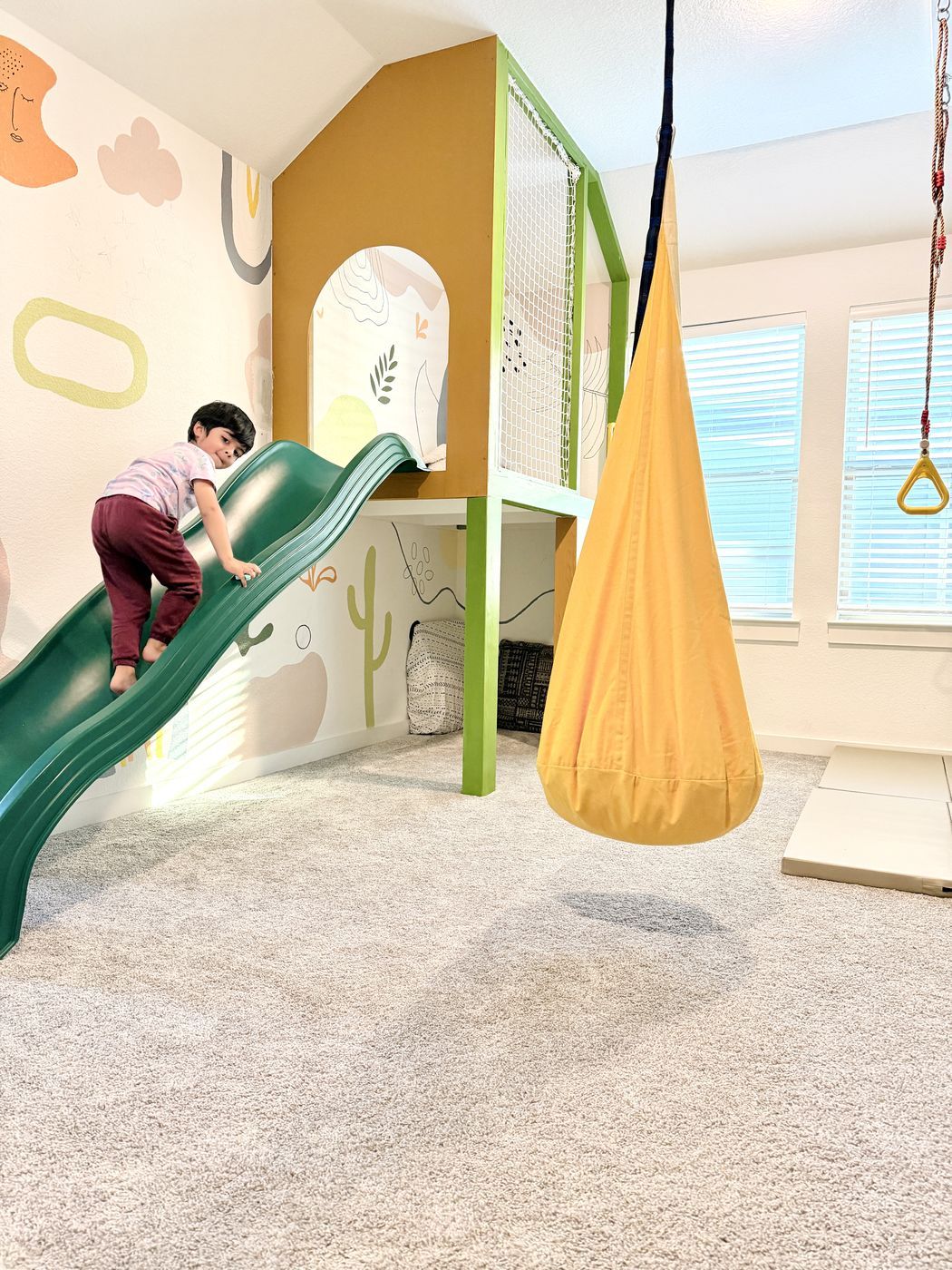 Child climbing green slide