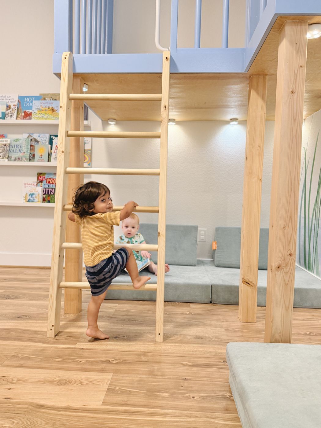 Child climbing wooden loft ladder