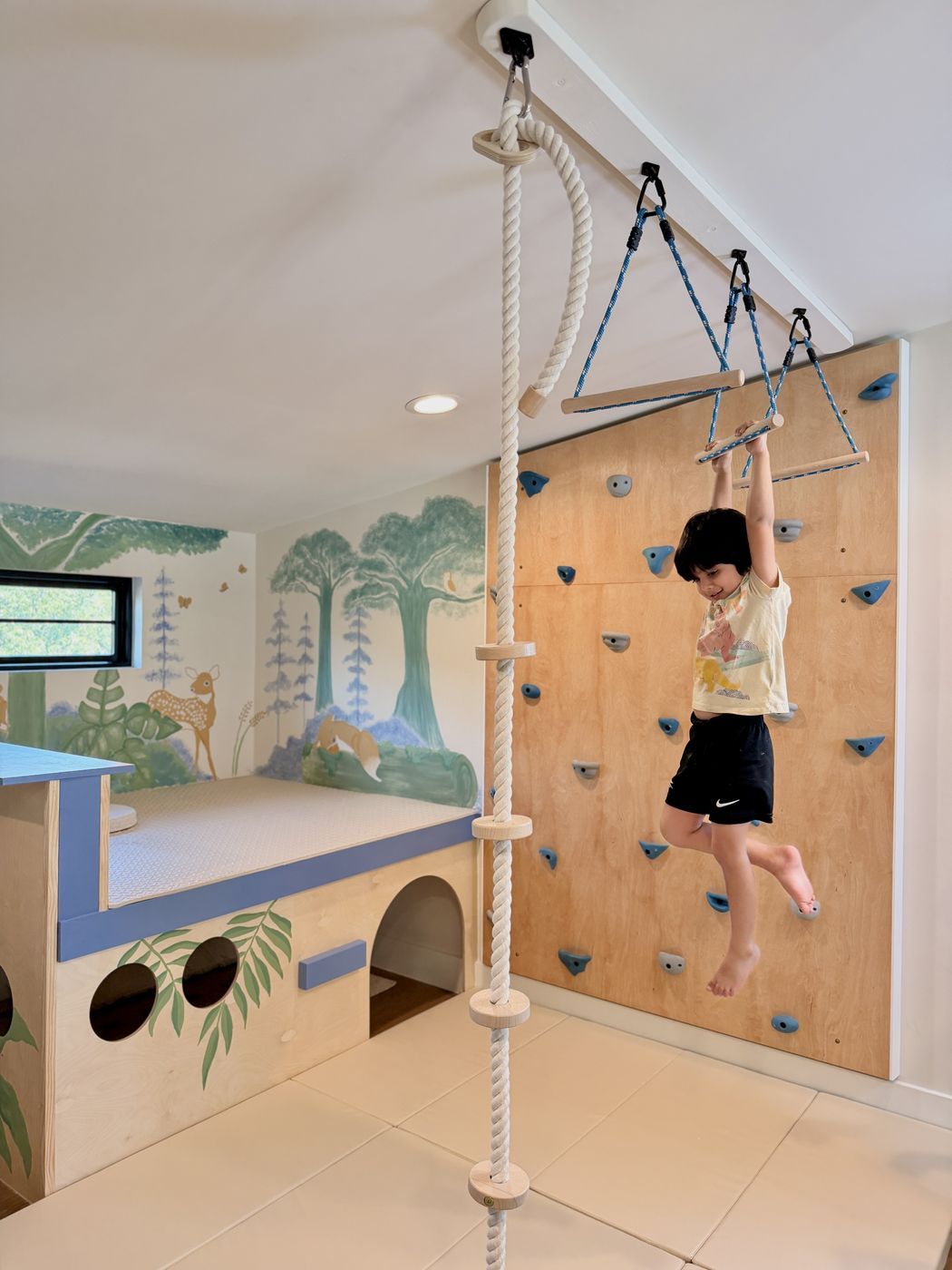 Child hanging from trapeze