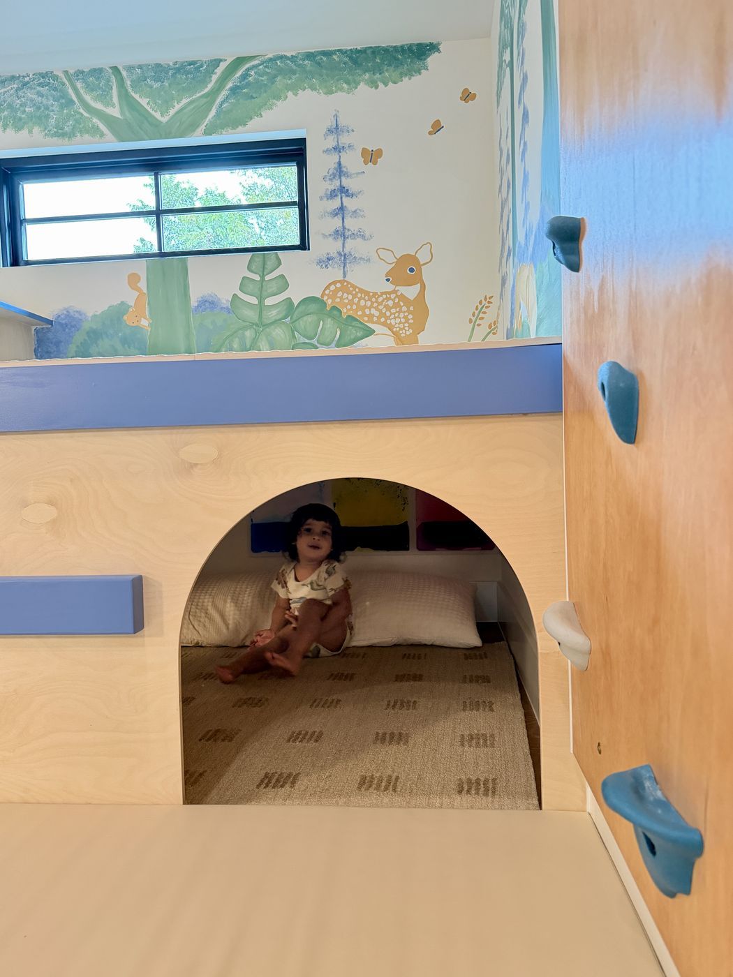 Child resting in under platform nook