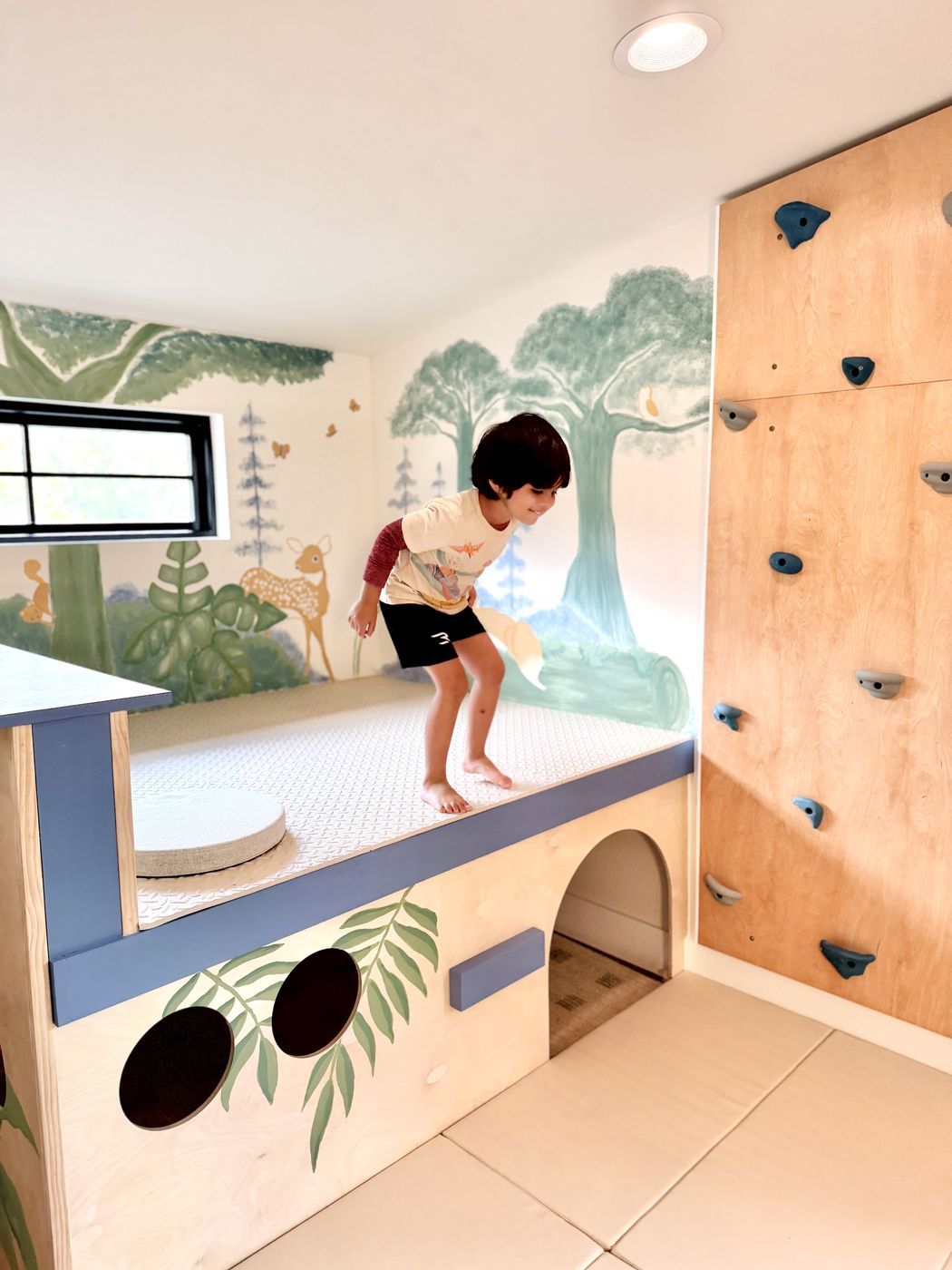 Child standing on padded play platform