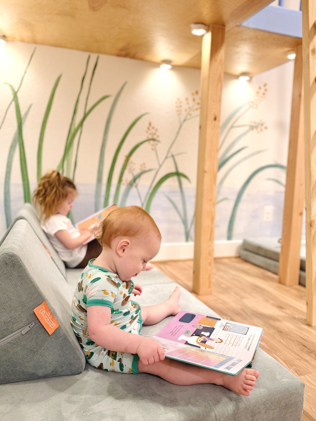 Children reading under play loft