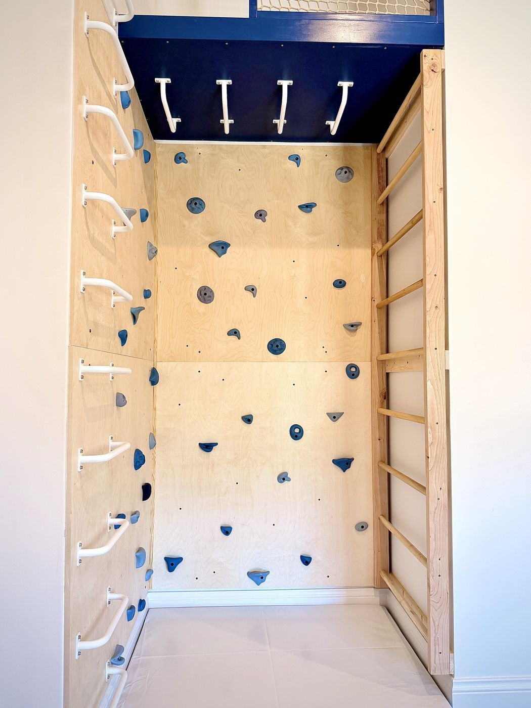 Climbing wall and padded floor front view