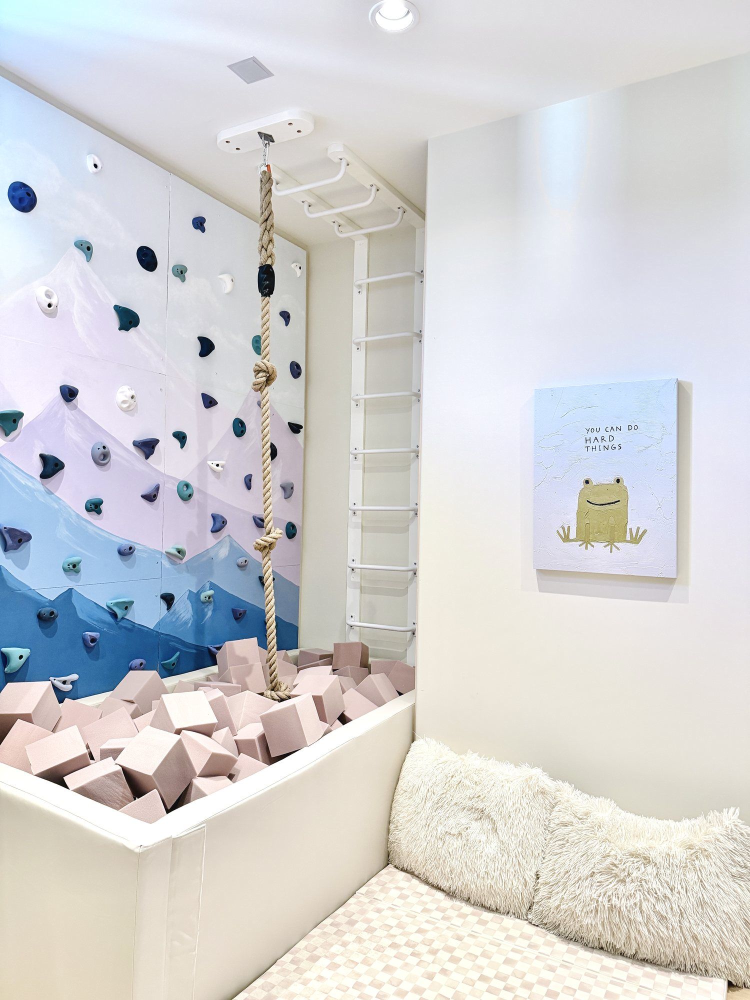 The Mountain Room: a mountain-painted climbing wall, a knotted rope and a foam pit