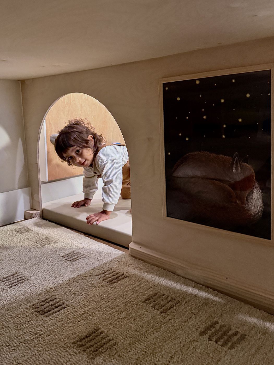 Toddler entering cozy playhouse