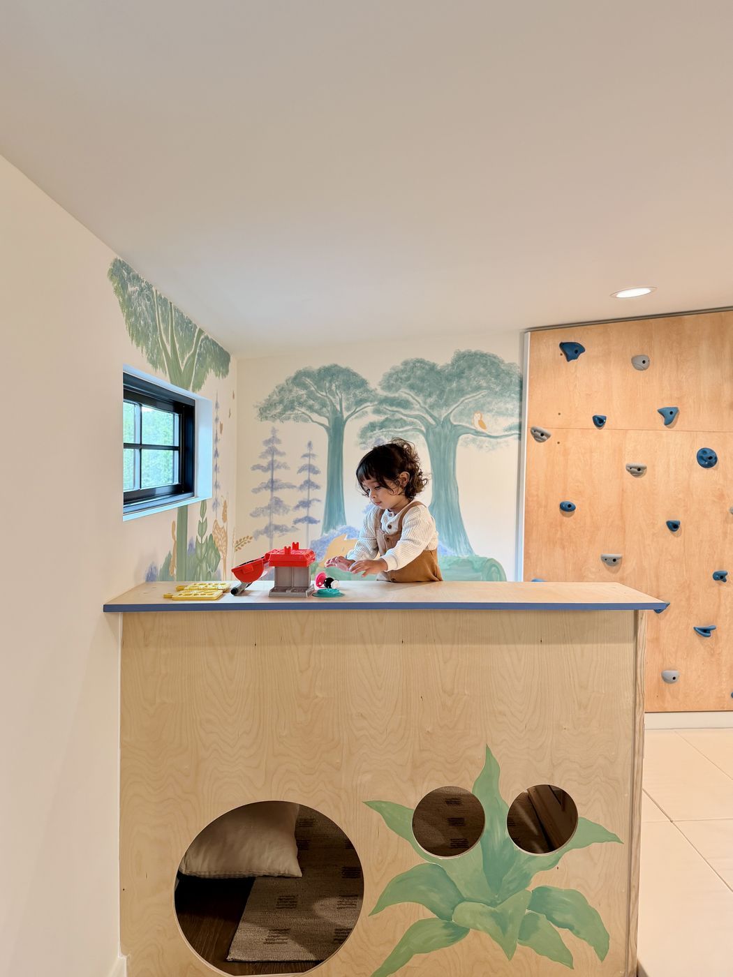 Toddler playing at wooden counter